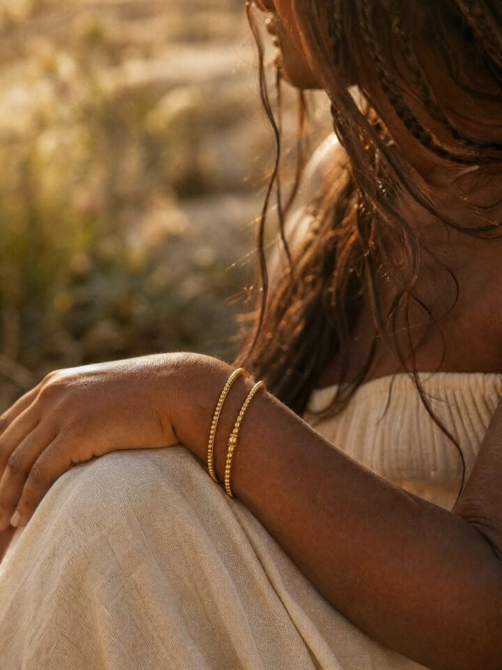 Slim Brass Bangle Pair worn in a summer meadow